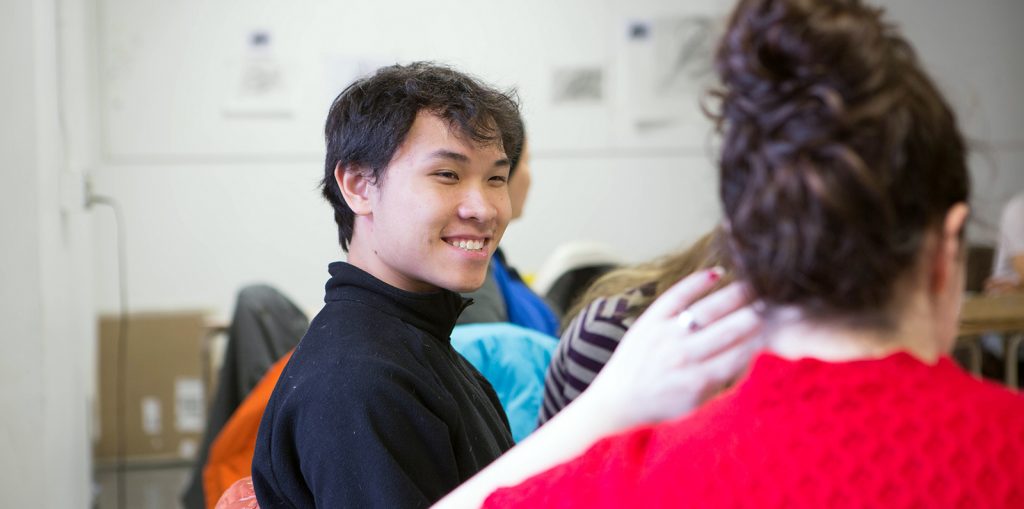 College student smiling in classroom.