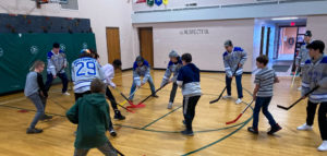 Finlandia Lions play floor hockey with South Range Elementary School students on MLK Day of Service 2023