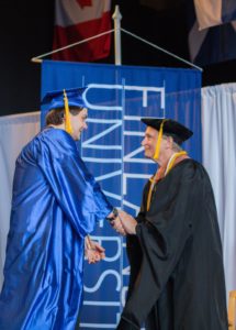 President Timothy Pinnow congratulates student at Finlandia's Spring 2023 Commencement Ceremony.